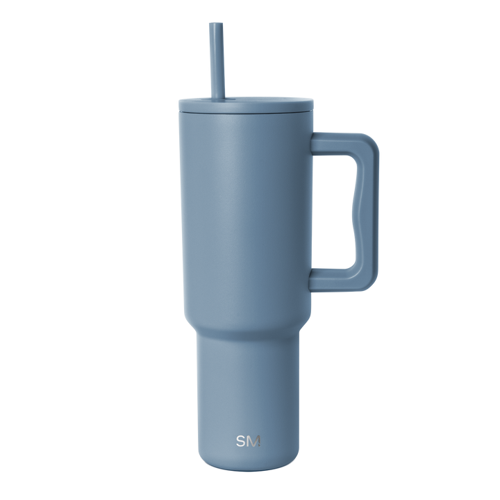 Slate blue insulated tumbler with tapered cylindrical design and minimalist contemporary aesthetic